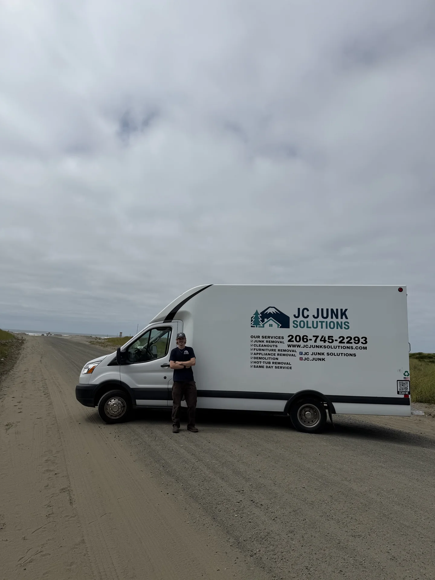JC Junk Solutions crew member beside the hauling truck