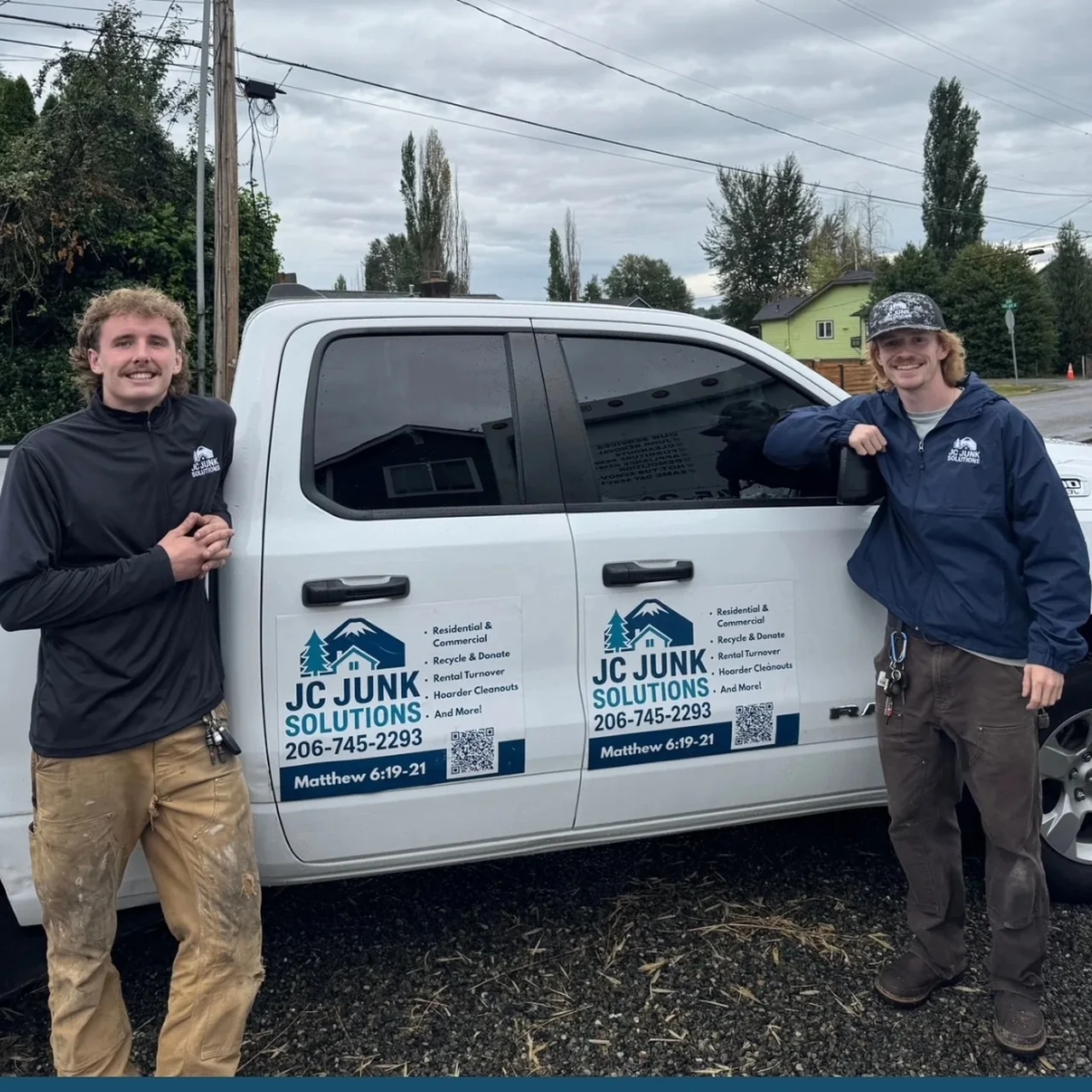 Two JC Junk Solutions crew members beside the company pickup truck