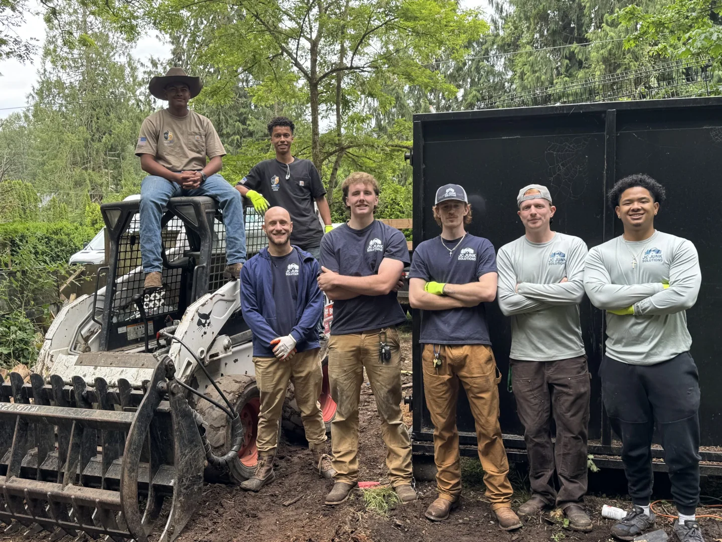 JC Junk Solutions team with equipment on a job site